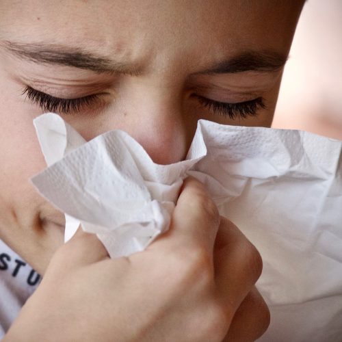 man blowing nose