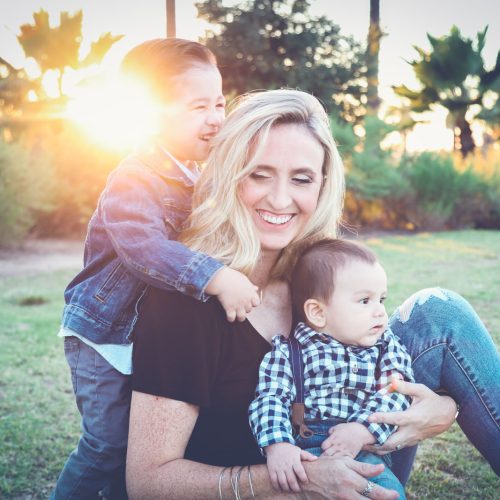 mother smiling with her two young children